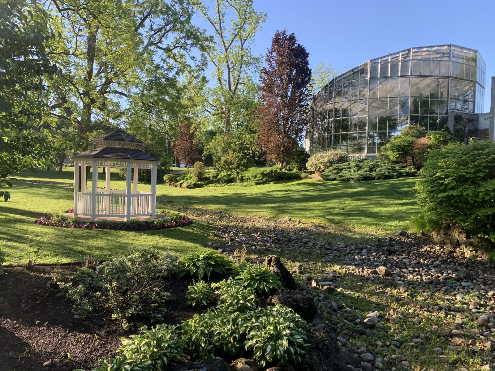 Gardens and gazebo beside a glass conservatory
